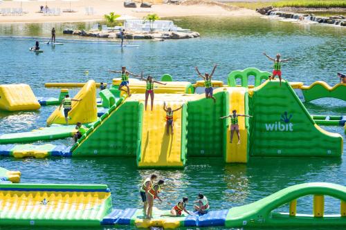 a group of people on a water slide in the water at Aloha Beach Resort in Wisconsin Dells