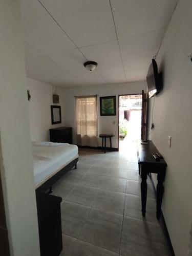 a room with a bed and a table in it at The Landing Hotel And Restaurant in Moyogalpa