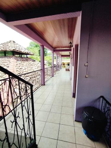 a balcony of a house with purple walls at The Landing Hotel And Restaurant in Moyogalpa