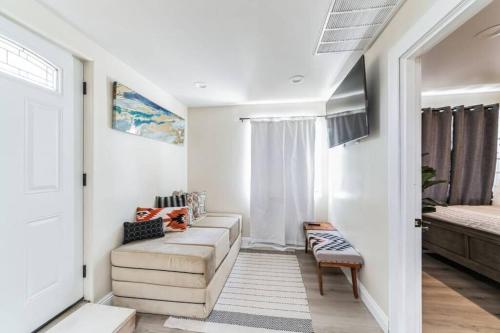a living room with a couch and a bed at Cozy 2 bdrm Home in the Heart of SCV near Six Flags in Santa Clarita
