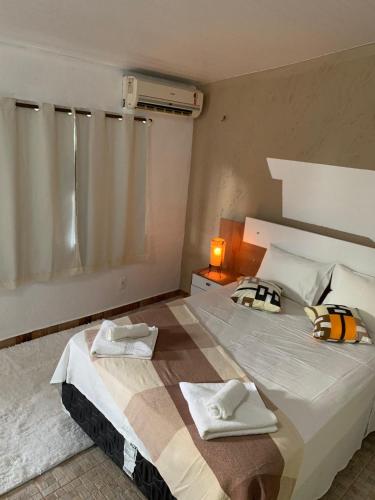 Ένα ή περισσότερα κρεβάτια σε δωμάτιο στο Pousada Villa Flamboyant
