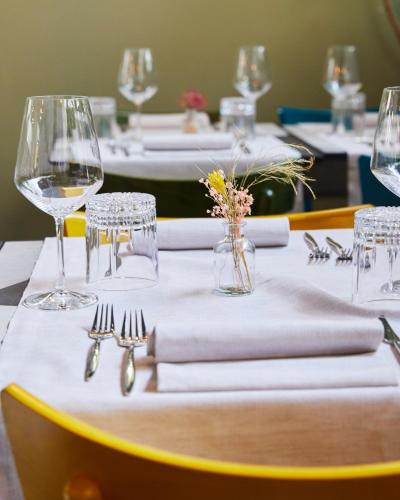 a table with white napkins and wine glasses on it at Apollo Boutique Hotel in Rome