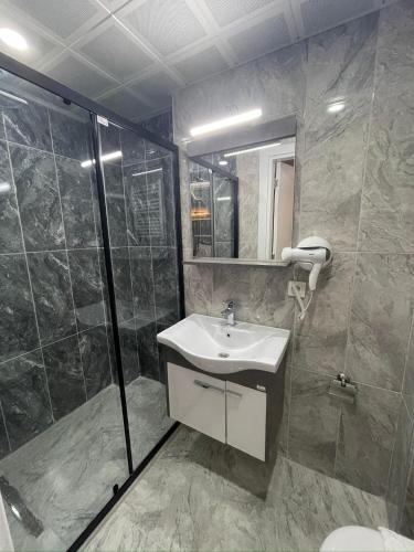a bathroom with a sink and a shower at Fabesco Suite in Istanbul