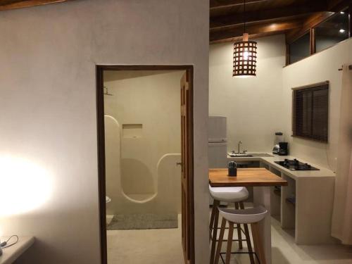 a kitchen with a counter and a table and chairs at Hotel Luz de Luna in Santa Teresa Beach