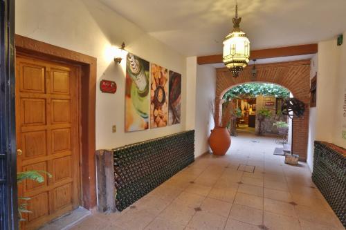 a hallway with a wooden door and an archway at Hotel Casa de Vino in Tequisquiapan