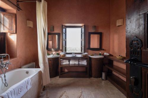 a large bathroom with a tub and a sink at Kasbah Agafay Hotel & Spa in El Karia