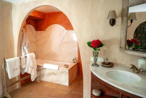 a bathroom with a sink and a bath tub at Can Serola in Sales del Llierca