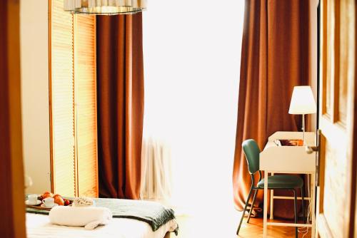 a bedroom with a bed and a chair and a window at Stanislawa Augusta by P&J Apartments in Warsaw