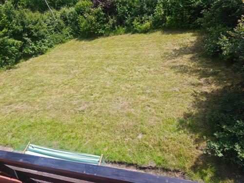 two green benches sitting on top of a grassy hill at IaM 3 Zimmer 90 qm Küche Badezimmer kraftraum 44 u in Plettenberg