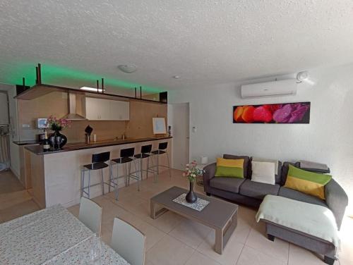 a living room with a couch and a kitchen at Villa Panoramica / La Nucia (Costa Blanca) in La Nucía