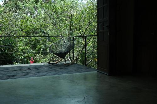 a basket chair sitting on a wooden deck at Casa Adobe Finca in La Peña