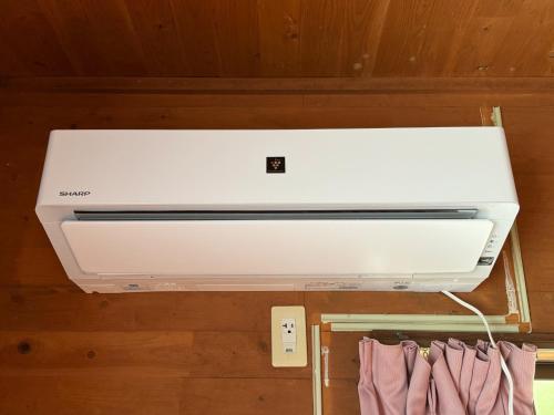 a white printer sitting on top of a wall at Agriland E, a village of dreams, wind and music - Vacation STAY 88882v in Ibusuki