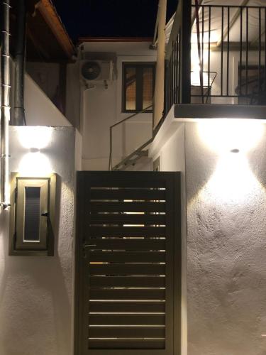 a hallway with stairs and lights in a building at Olive green house in Skiathos