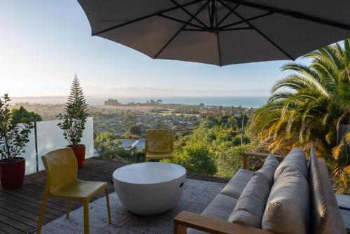 a patio with an umbrella and a table and chairs at Tosswill Road - Bay Vista in Nelson