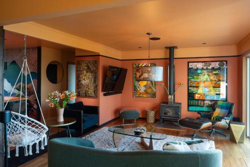 a living room with orange walls at Tosswill Road - Bay Vista in Nelson