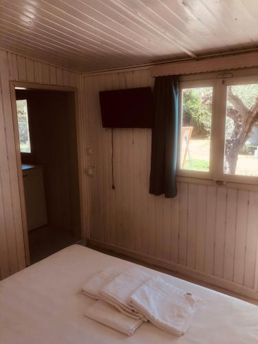 a bed in a room with a window at Barreira Beachfront Rooms 6 in Kalamata