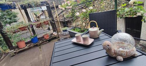 a table on a balcony with a lot of plants at Alex in Chambave