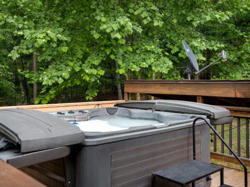 a hot tub sitting on top of a deck at Shenandoah dog friendly cabin with river access, hot tub, fire pit, BBQ, outdoor dining in Shenandoah