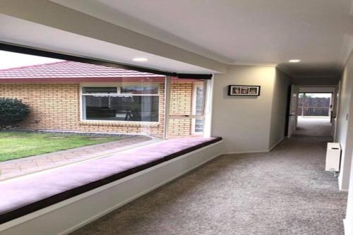 a empty room with a large window in a house at Quiet and comfortable in Hamilton