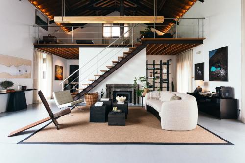 a living room with a couch and a fireplace at Pico do Refúgio - Casas de Campo in Ribeira Grande
