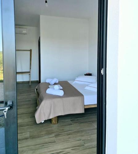 a bedroom with a bed with towels on it at Ambelas Getaways in Himare