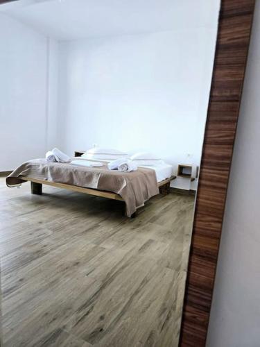 a mirror reflection of a bed in a room at Ambelas Getaways in Himare