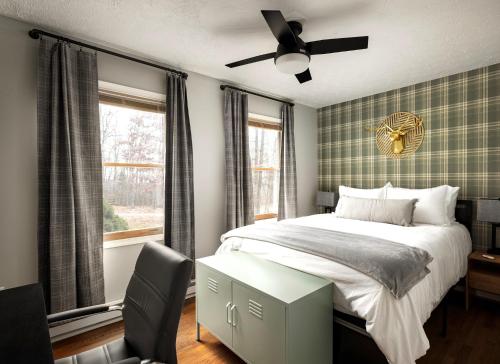 a bedroom with a bed and a ceiling fan at Shenandoah dog friendly cabin with river access, hot tub, fire pit, BBQ, outdoor dining in Shenandoah