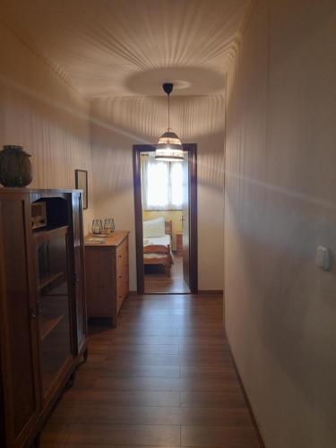 a hallway with a door to a bedroom with a bed at Mountain and Sea view in Miléai