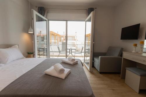 Postel nebo postele na pokoji v ubytování Porto Dionysos
