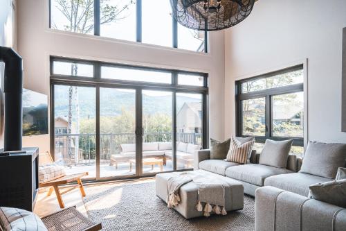 a living room with two couches and a large window at Tremblant Prestige - Verbier 9-205 in Mont-Tremblant