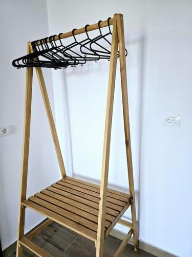 a wooden stand with a bench in a room at Ambelas Getaways in Himare
