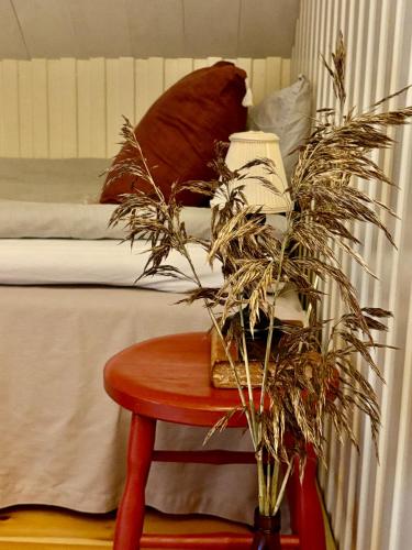 a bedroom with a bed and a table with a bed at Lydde Gård in Kinna