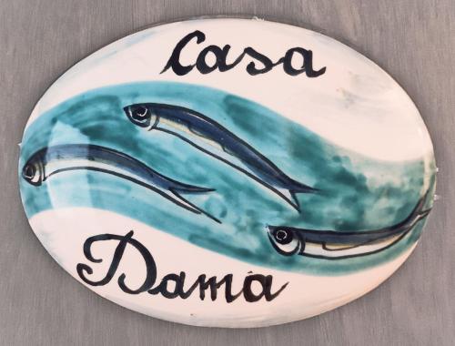 a plate with two fish swimming in the water at Casa Dama in Vietri sul Mare