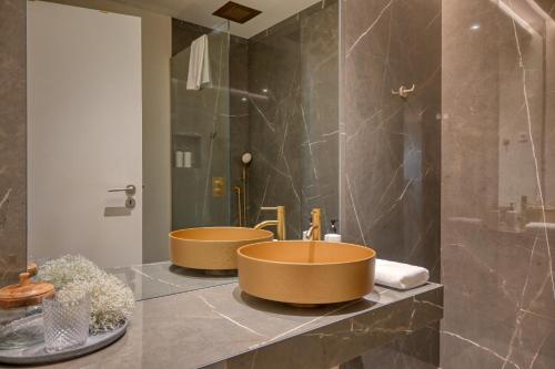 a bathroom with two sinks on a counter at Colombo Square, a Home in Madeira in Funchal
