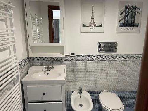 a bathroom with a sink and a toilet and a mirror at Nella valle dei templi e al mare in Villaggio Mosè