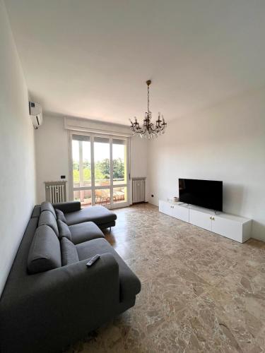 a living room with a couch and a flat screen tv at mirabello in Reggio Emilia