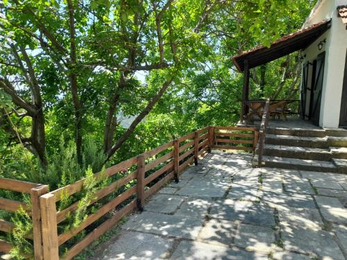 a wooden walkway leading to a house with a fence at Mountain and Sea view in Miléai