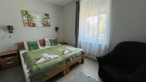 Postel nebo postele na pokoji v ubytování Vitality Apartman