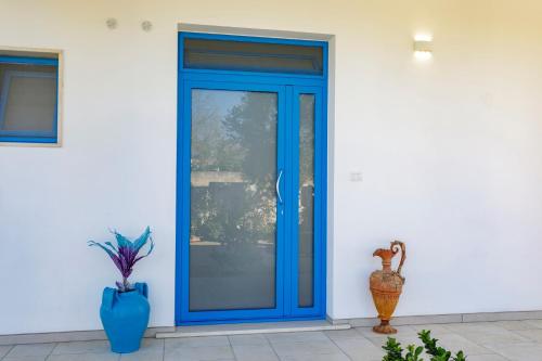 a blue door on the side of a house at Villa Rebecca in Nardò