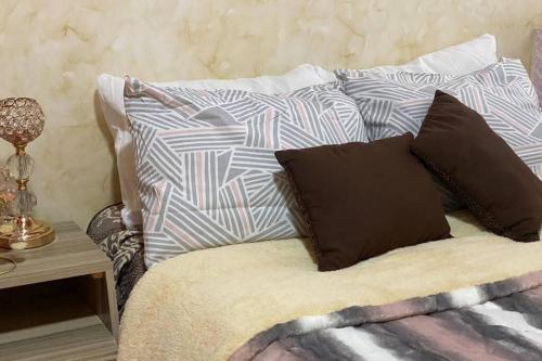 a bed with two pillows on top of it at Casa Hogar Feliz in San Juan de los Lagos