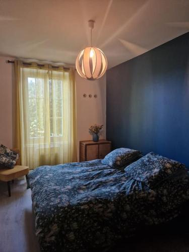 une chambre avec un lit et un mur bleu dans l'établissement Charmant appartement avec jardin, à Larressore