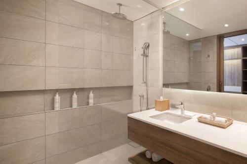 a bathroom with a sink and a shower at Santa Marta Marriott Resort Playa Dormida in Santa Marta