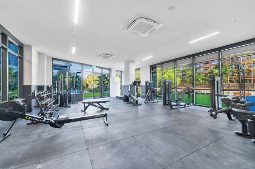 a gym with treadmills and cardio equipment in a building at City views & New 3b2b1p Apt in Homebush in Sydney