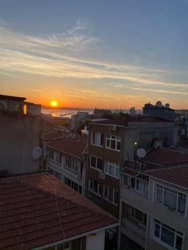 a view of the sunset from the roofs of buildings at Fabesco Suite in Istanbul