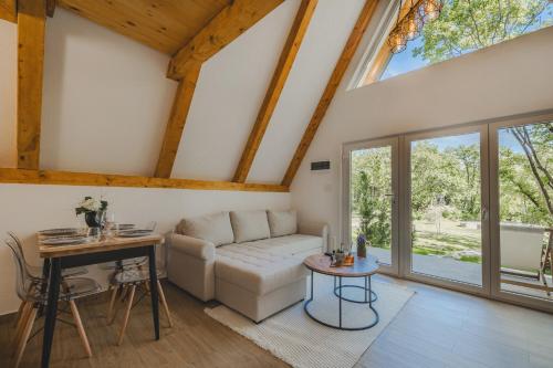 a living room with a white couch and a table at Vukova dolina apartments in Cetinje