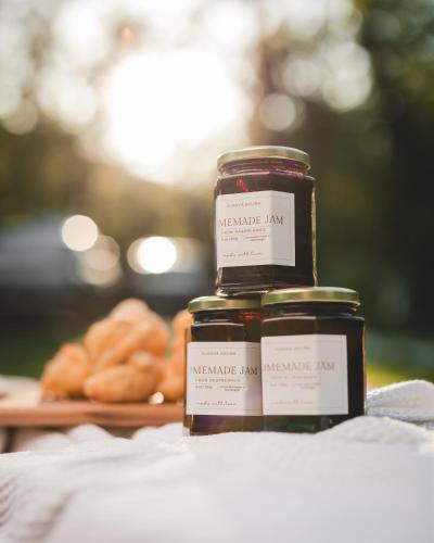two jars of jam next to a plate of donuts at Vukova dolina apartments in Cetinje