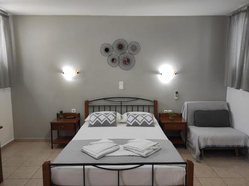 a bedroom with a bed with two towels on it at Vythos in Adamas