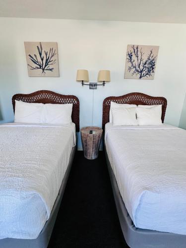 two beds sitting next to each other in a room at Ragged Edge Resort & Marina in Islamorada