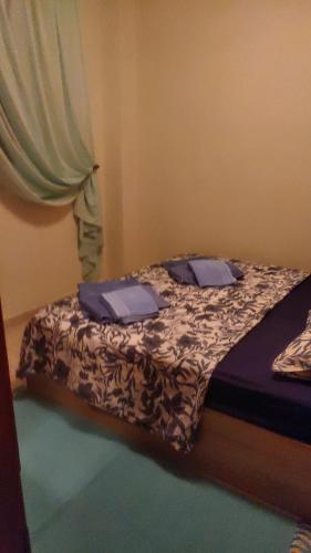 a small bed with blue pillows in a bedroom at Blue lagoon in Skála Foúrkas