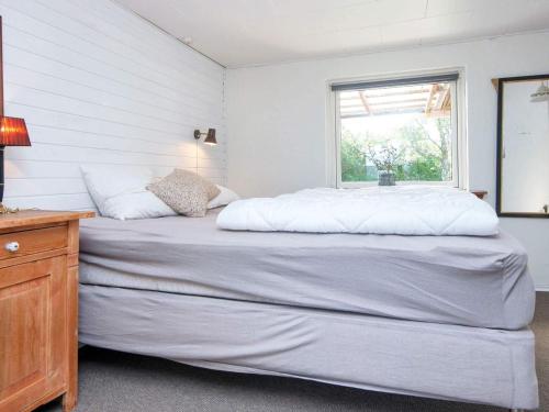 a large bed in a room with a window at 5 person holiday home in Skjern-By Traum in Skjern